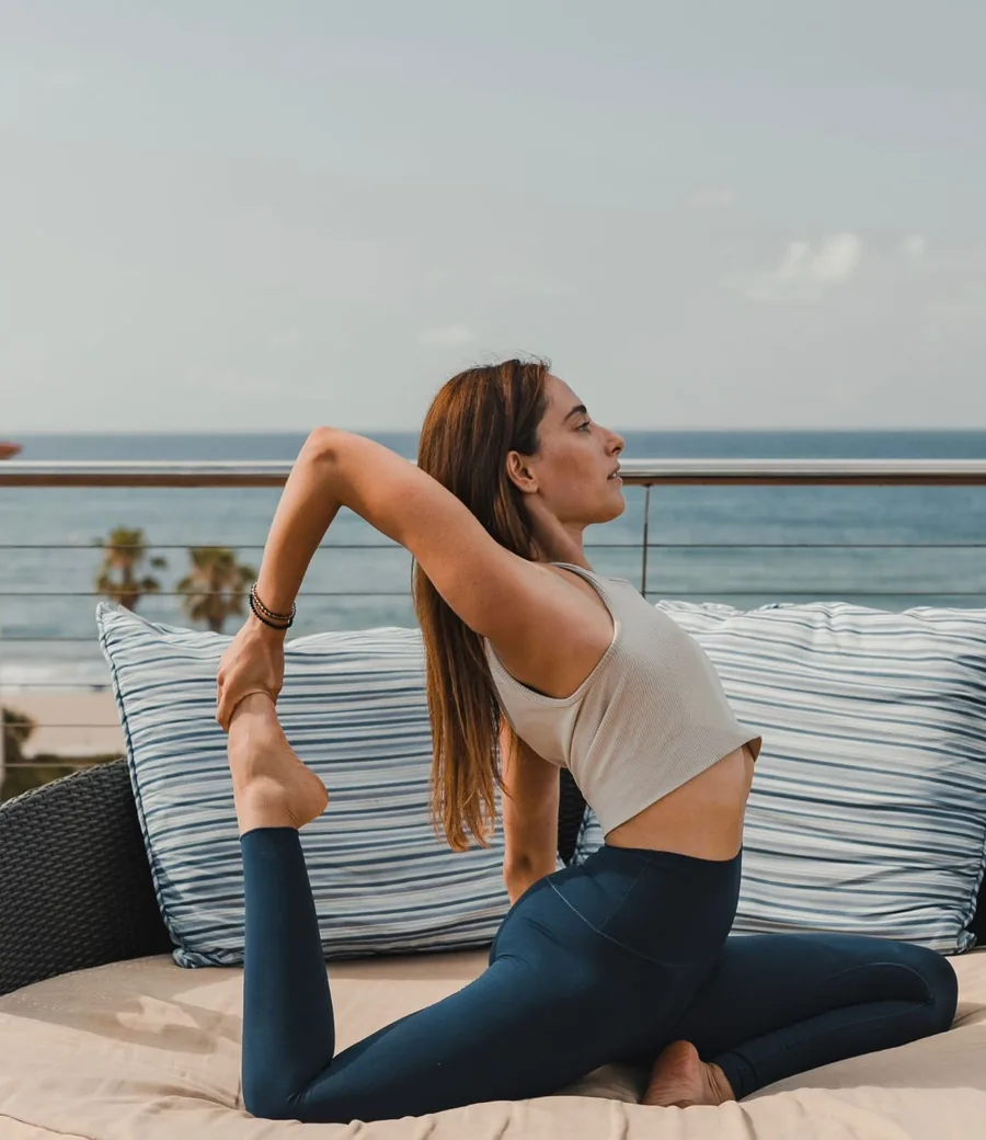 Eva García practicing yoga by the ocean