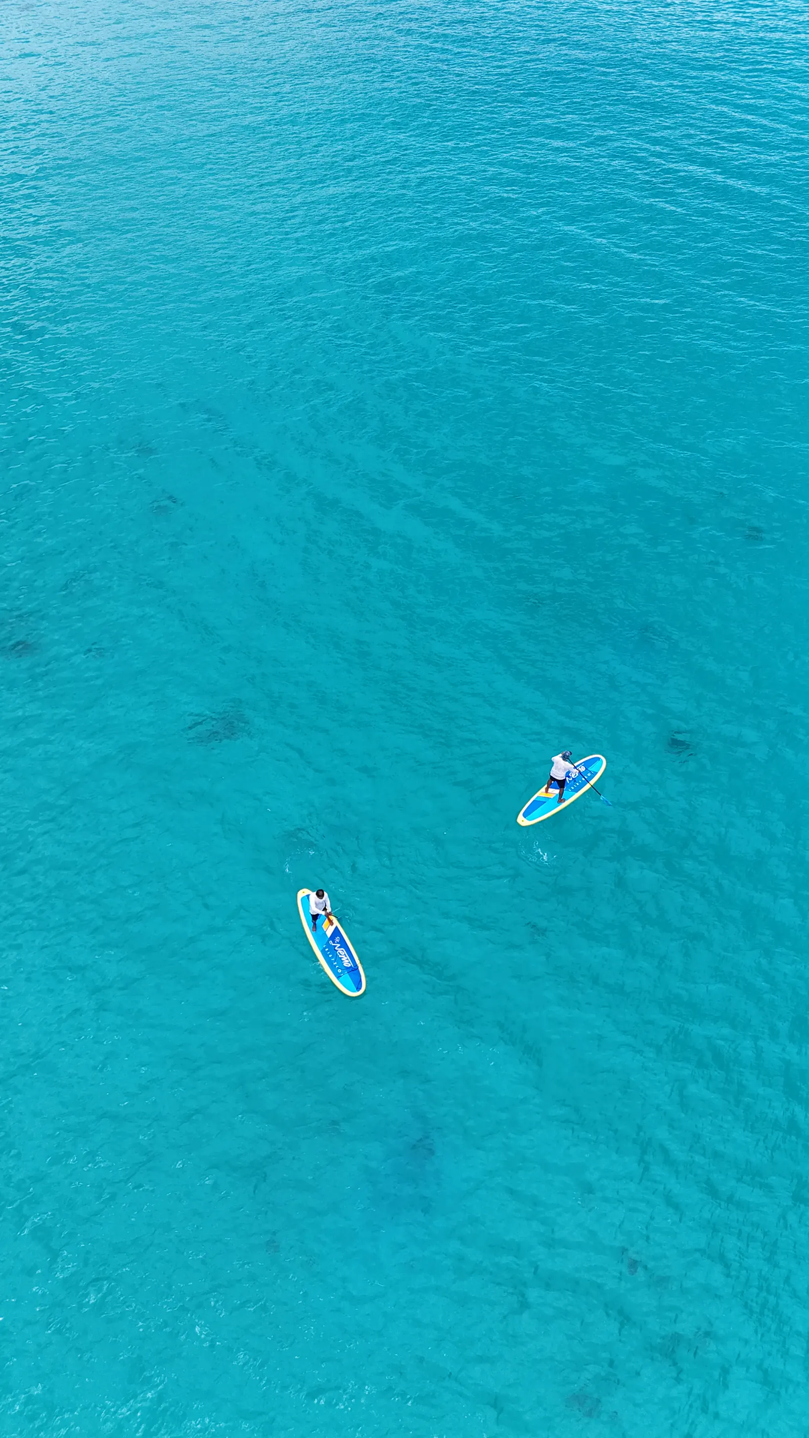 Paddleboarding over turquoise water in Galapagos
