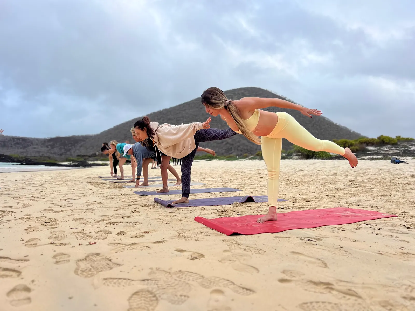 Group practicing yoga on a Galapagos beach