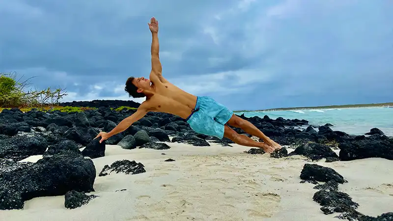 Jan Erazo practicing yoga on the beach during the Galápagos Retreat