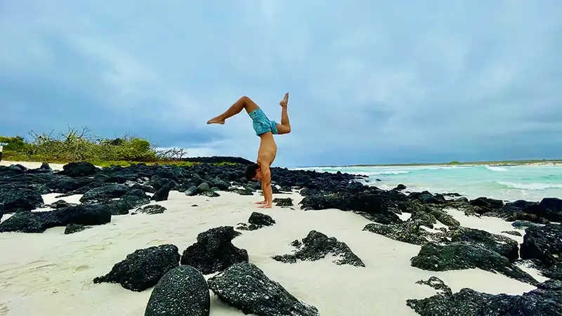 Jan Erazo performing a handstand on the beach during the Galápagos Yoga Retreat
