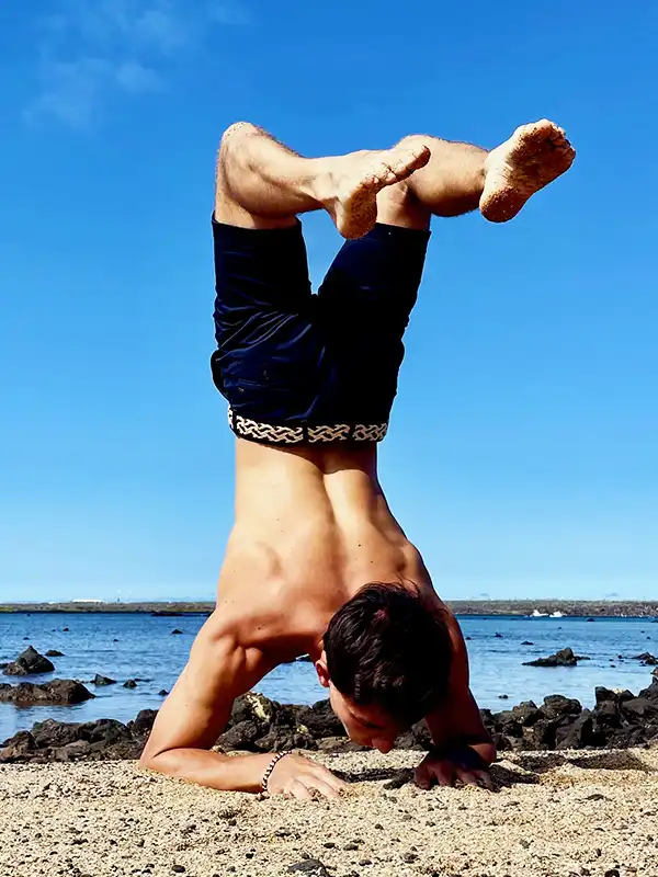 Jan performing a headstand on the beach during the Galápagos Yoga Retreat