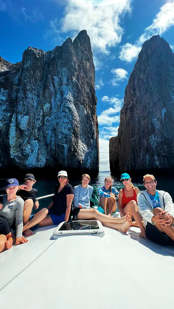 Retreat group exploring Kicker Rock with Carolina in the Galápagos Carolina and retreat participants on a boat in front of Kicker Rock in the Galápagos
